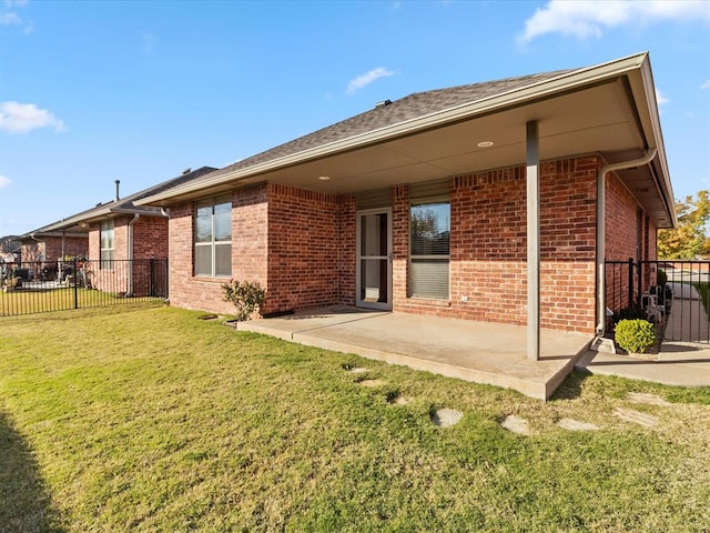 rear view of house featuring a patio area and a yard