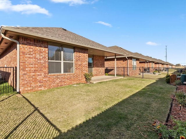 rear view of property featuring a yard and a patio