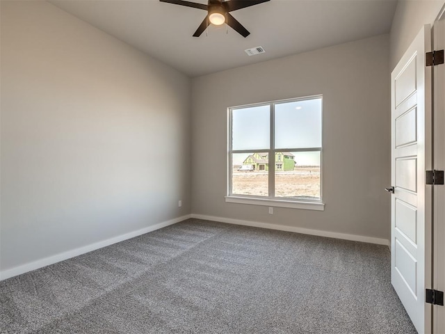 spare room with ceiling fan and carpet floors