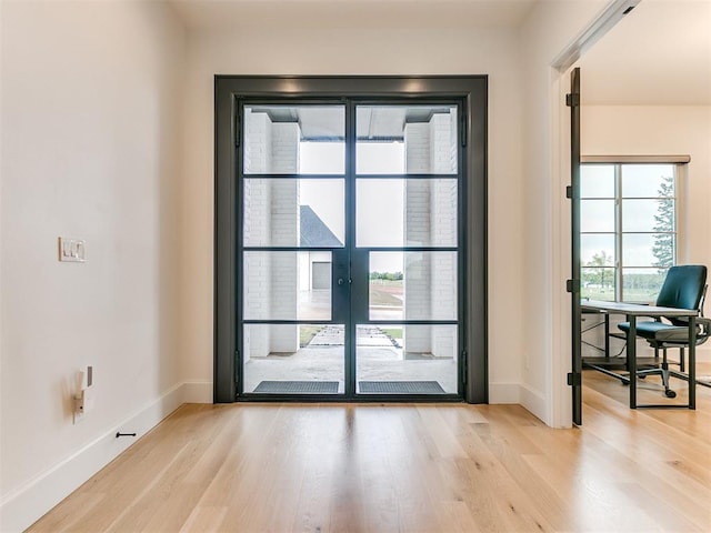 doorway to outside with light hardwood / wood-style flooring