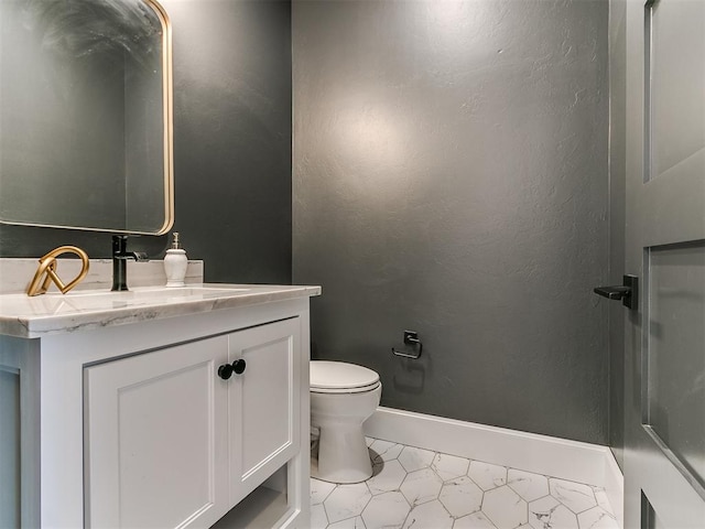 bathroom featuring tile patterned flooring, vanity, and toilet