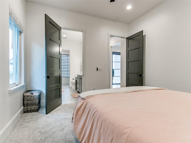 carpeted bedroom featuring ensuite bath