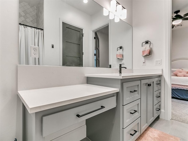 bathroom featuring tile patterned flooring, vanity, ceiling fan, and curtained shower