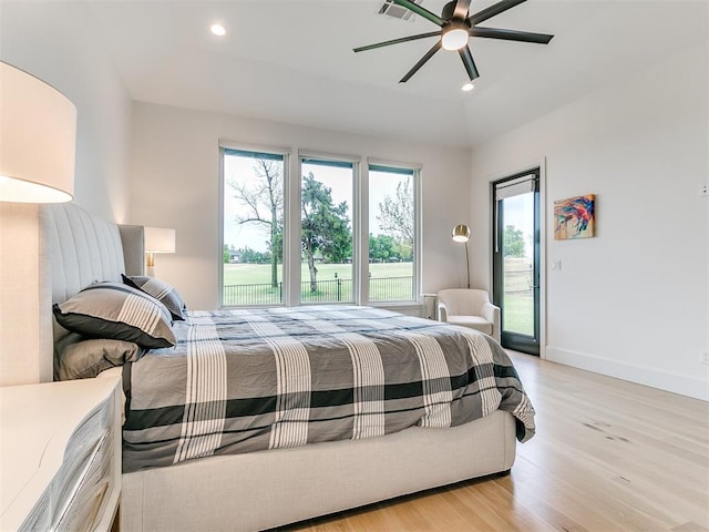 bedroom featuring access to exterior, light hardwood / wood-style flooring, and ceiling fan