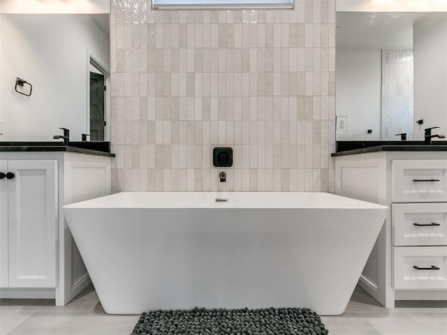 bathroom featuring tile patterned floors, vanity, and tile walls