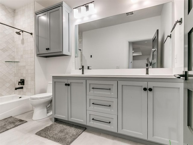 full bathroom with tile patterned floors, toilet, vanity, and tiled shower / bath