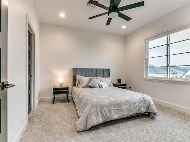 bedroom with ceiling fan and light carpet