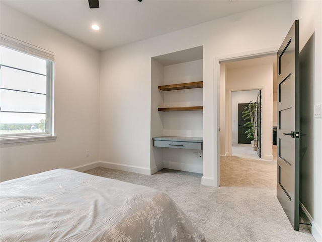 unfurnished bedroom with light carpet and ceiling fan