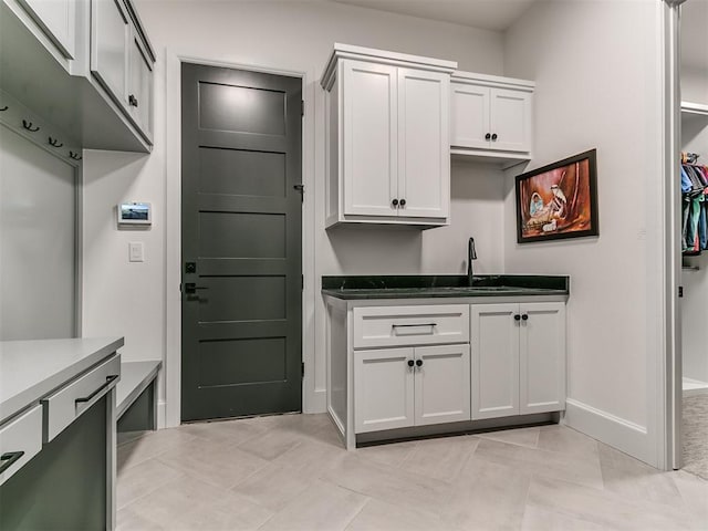 kitchen with white cabinetry and sink