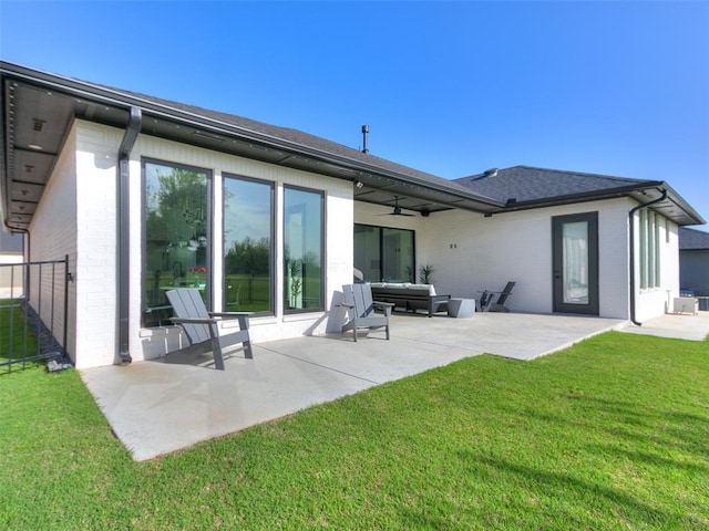 rear view of house with a lawn, ceiling fan, a patio, and an outdoor hangout area