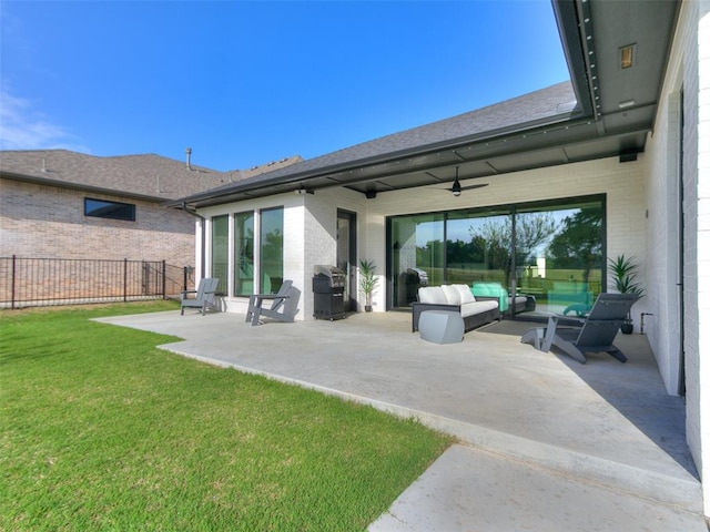 back of house featuring a patio area, ceiling fan, and a yard