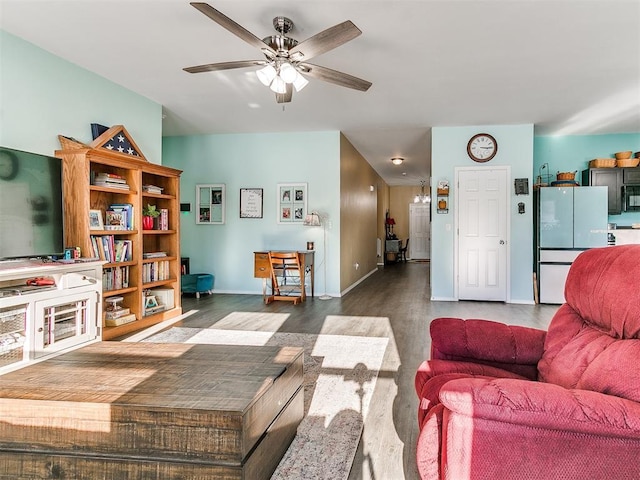 living room featuring ceiling fan and dark wood-type flooring