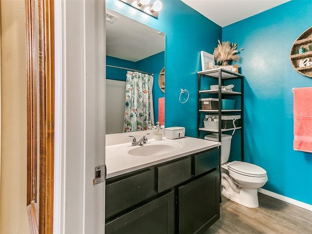 bathroom featuring hardwood / wood-style floors, vanity, toilet, and a shower with curtain