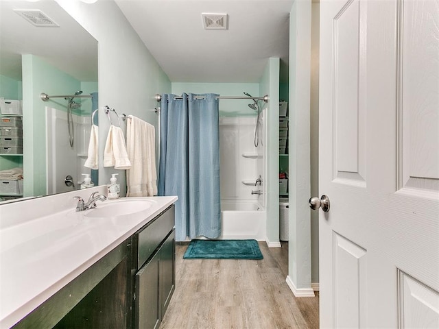 bathroom with shower / tub combo with curtain, vanity, and hardwood / wood-style flooring