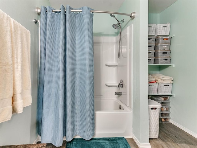 bathroom with shower / tub combo and hardwood / wood-style flooring