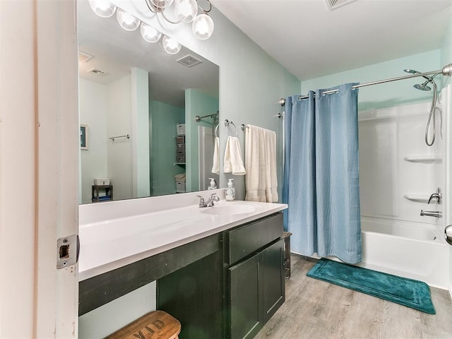 bathroom with vanity, shower / bathtub combination with curtain, and wood-type flooring