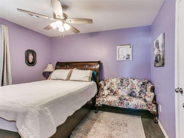 bedroom featuring dark hardwood / wood-style floors and ceiling fan