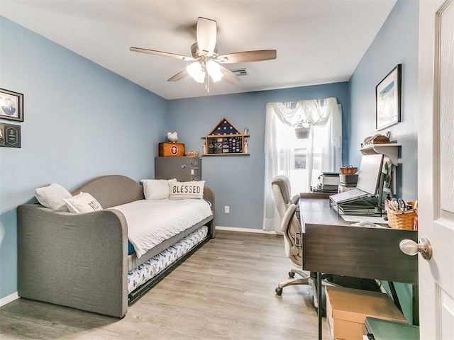 office space with light hardwood / wood-style flooring and ceiling fan