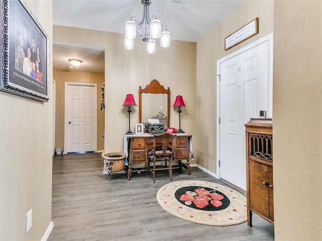 foyer entrance with hardwood / wood-style flooring and a notable chandelier