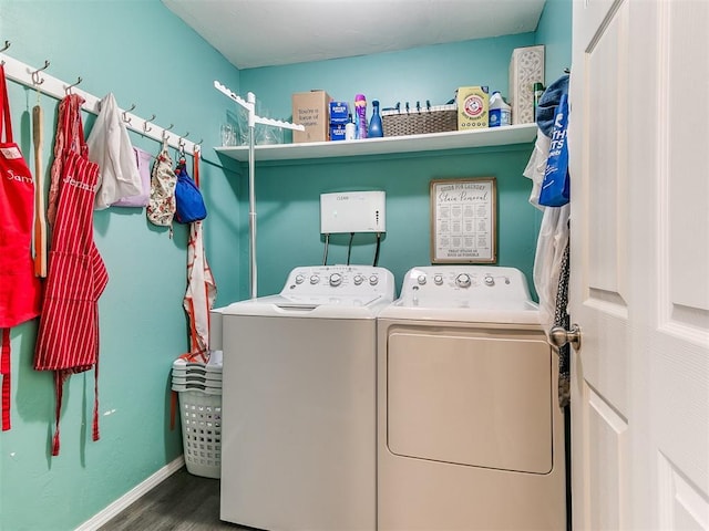 laundry area featuring hardwood / wood-style flooring and washing machine and clothes dryer