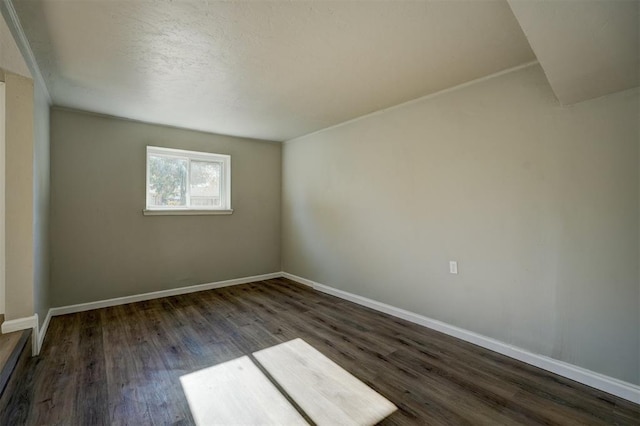 unfurnished room with dark hardwood / wood-style floors