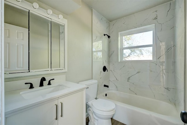 full bathroom featuring toilet, vanity, and tiled shower / bath