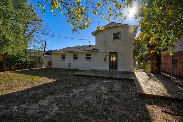 back of house featuring a wooden deck