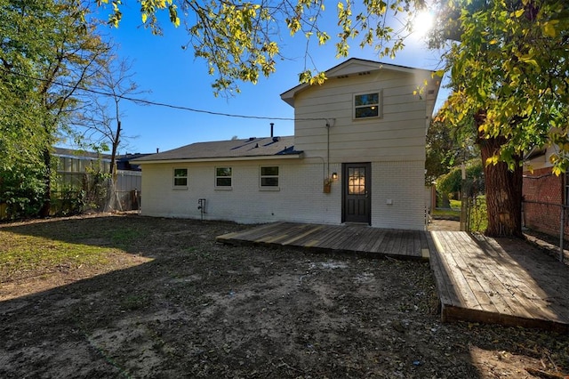 back of property with a wooden deck