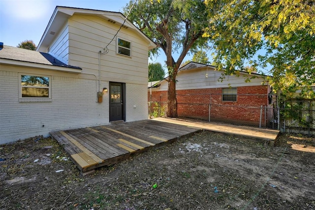 rear view of house featuring a wooden deck