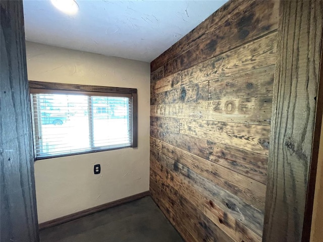 spare room with wood walls