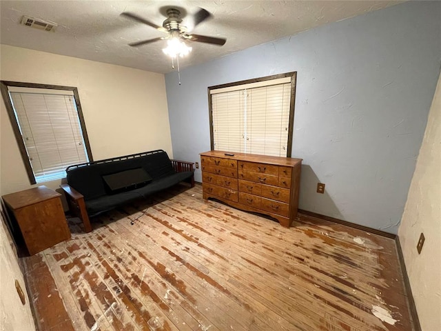 living area featuring light hardwood / wood-style flooring and ceiling fan