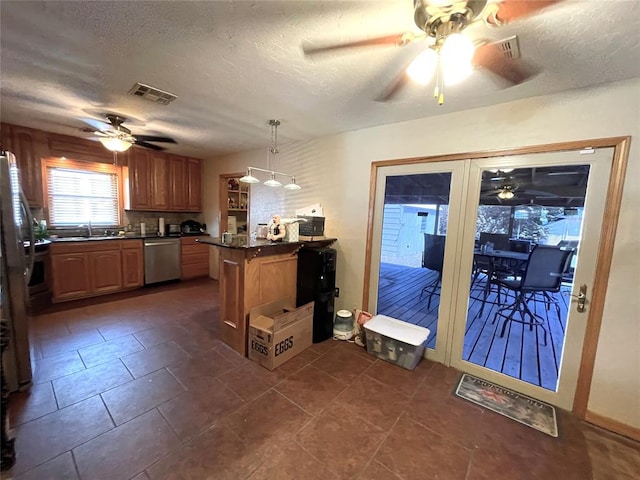 kitchen with a textured ceiling, kitchen peninsula, dishwasher, and decorative light fixtures