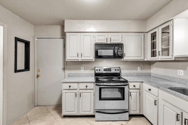 kitchen featuring light stone counters, a textured ceiling, white cabinetry, stainless steel range with electric cooktop, and light tile patterned flooring