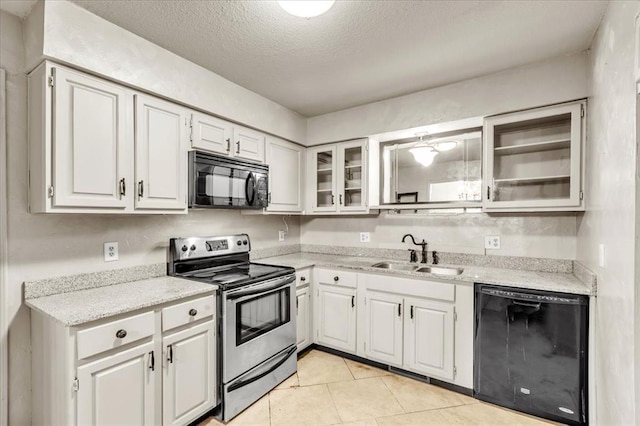 kitchen with black appliances, sink, a textured ceiling, light tile patterned flooring, and white cabinetry