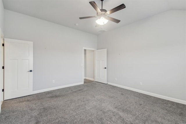 spare room featuring vaulted ceiling, carpet flooring, and ceiling fan