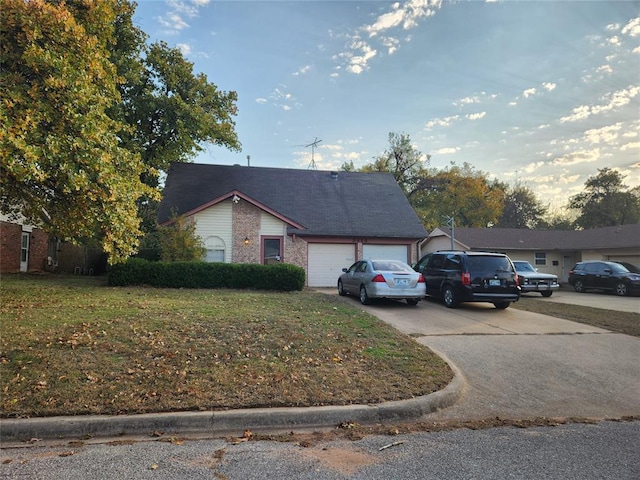 view of front of house with a garage and a front lawn