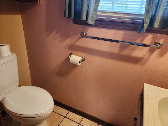 bathroom with tile patterned floors and toilet