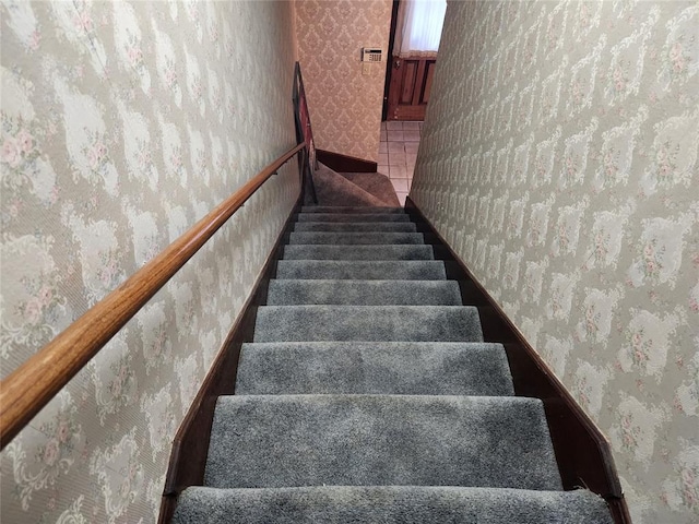 stairs featuring tile patterned flooring