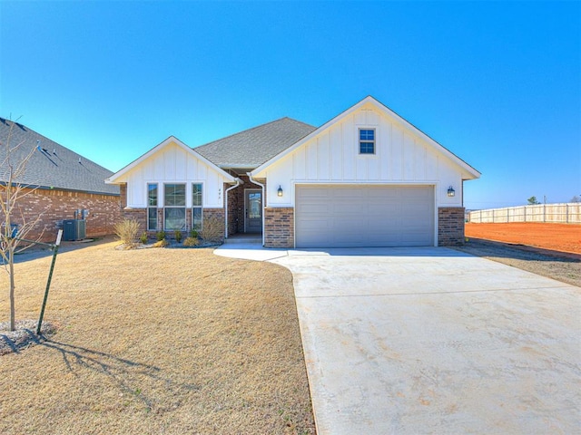 view of front of home featuring central AC unit and a garage