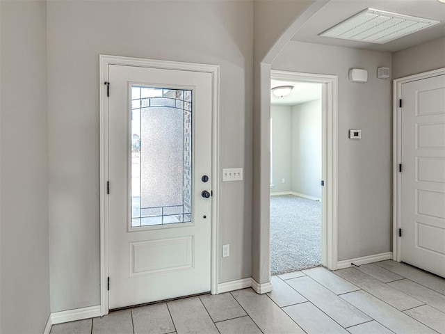 foyer featuring a wealth of natural light and light tile patterned flooring