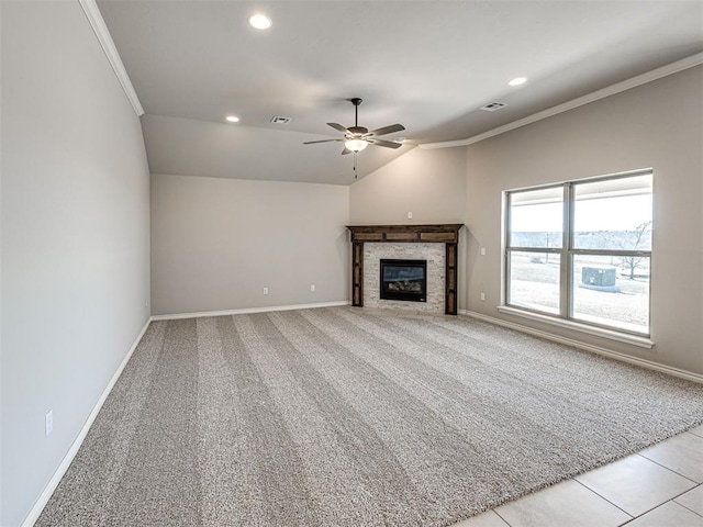 unfurnished living room featuring ceiling fan, lofted ceiling, ornamental molding, and light tile patterned floors