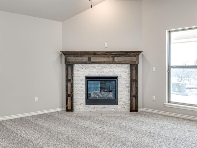 room details featuring carpet floors and a stone fireplace