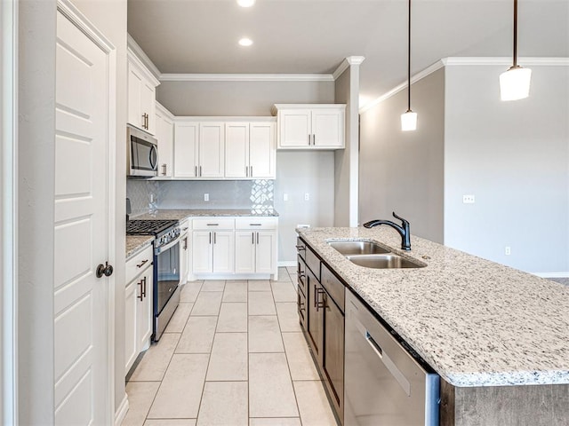 kitchen featuring a center island with sink, white cabinetry, sink, and appliances with stainless steel finishes