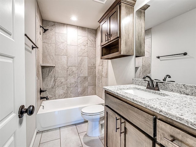 full bathroom with tile patterned flooring, vanity, tiled shower / bath combo, and toilet