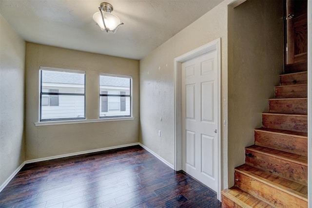 stairway with hardwood / wood-style flooring