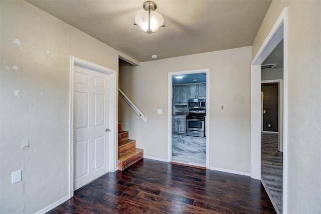 spare room with dark wood-type flooring