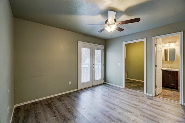 spare room featuring french doors, light hardwood / wood-style flooring, and ceiling fan