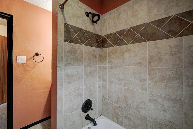 interior details featuring tiled shower / bath