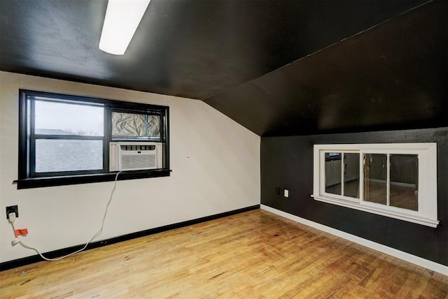 bonus room with light hardwood / wood-style floors, cooling unit, and lofted ceiling