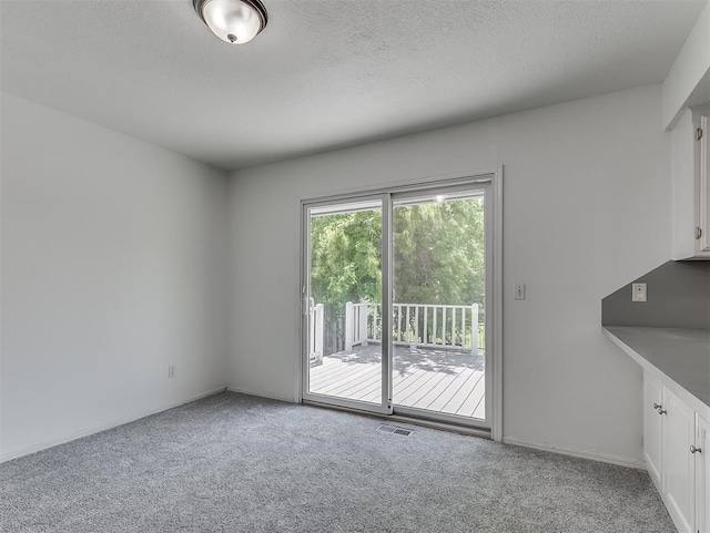 6404 Westway, Oklahoma City, OK 73142 - unfurnished dining area with carpet and a textured ceiling